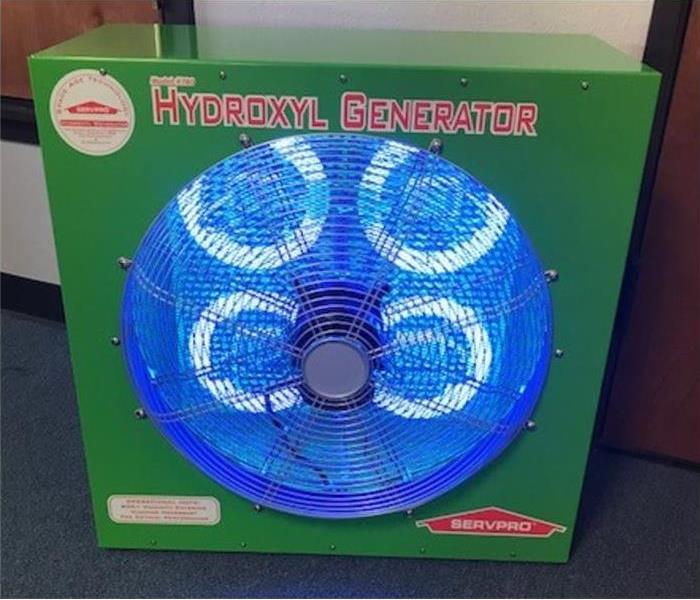 Green SERVPRO hydroxyl generator shaped like a cube with 4 blue ring lights inside 